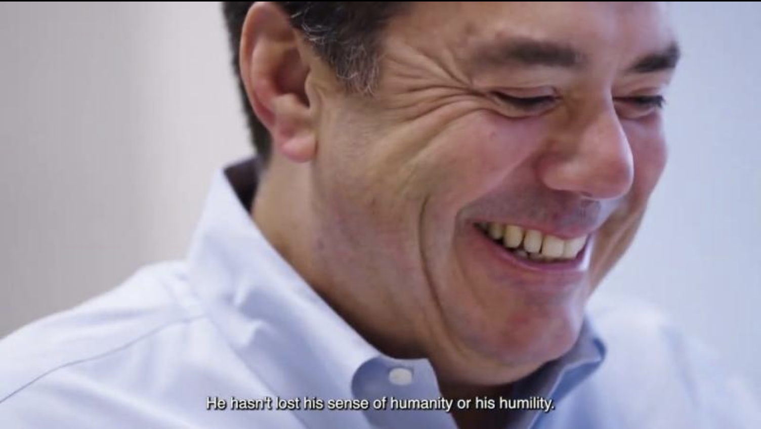 fred rivera wearing a button down white shirt and smiling